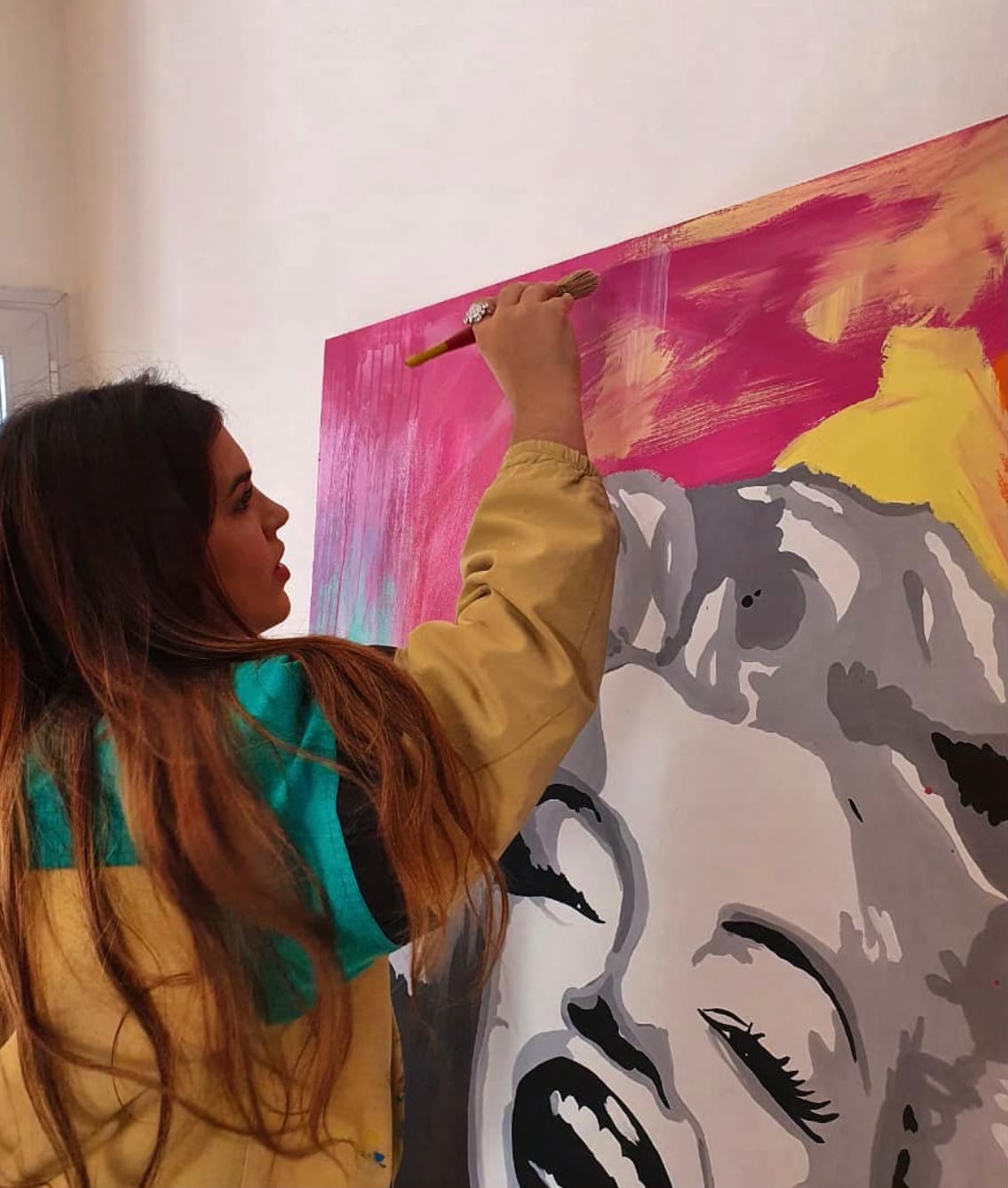 Florencia painting a large artwork